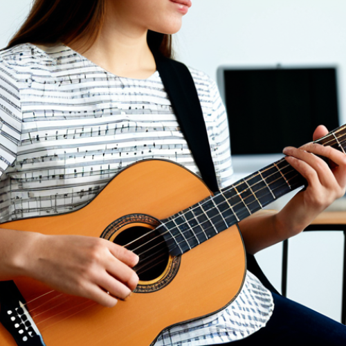 Home 9 A professional female guitarist, shown from the waist up, dressed in modest business casual attire. She is in a well-lit, clean home studio, attentively comparing a printed sheet of traditional musical notation and guitar tablature with a digital version displayed on a tablet. A classical guitar is visible in the background. Professional studio photography, soft natural light, high detail, perfect anatomy, correct proportions, well-formed hands, proper finger count, natural body proportions, natural pose, safe for work, appropriate content, fully clothed, professional.