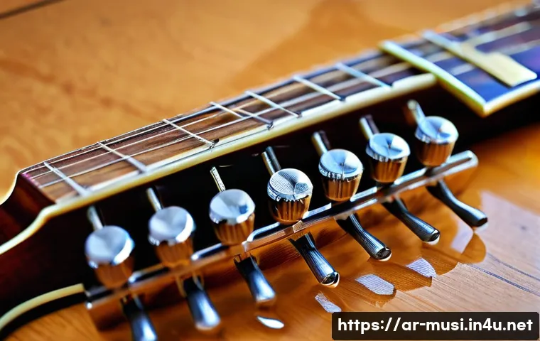 기타 튜닝 머신 종류 - A detailed close-up image of a traditional mechanical guitar tuner made of polished metal, mounted o...